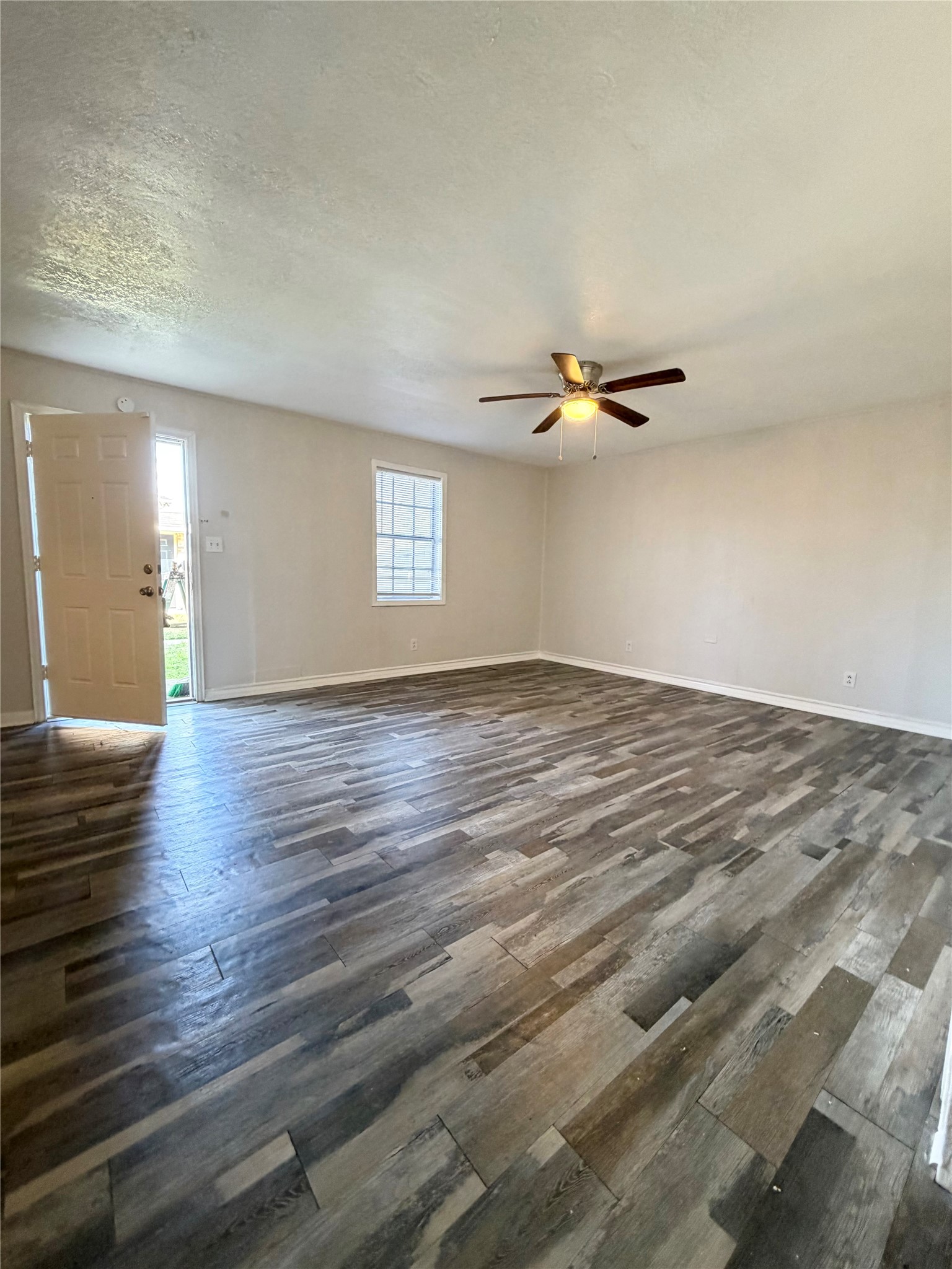 1614 Vauthier Street, Unit 11 La Marque, TX 77568 - Photo 13 of 16 a view of an empty room with wooden floor and a window