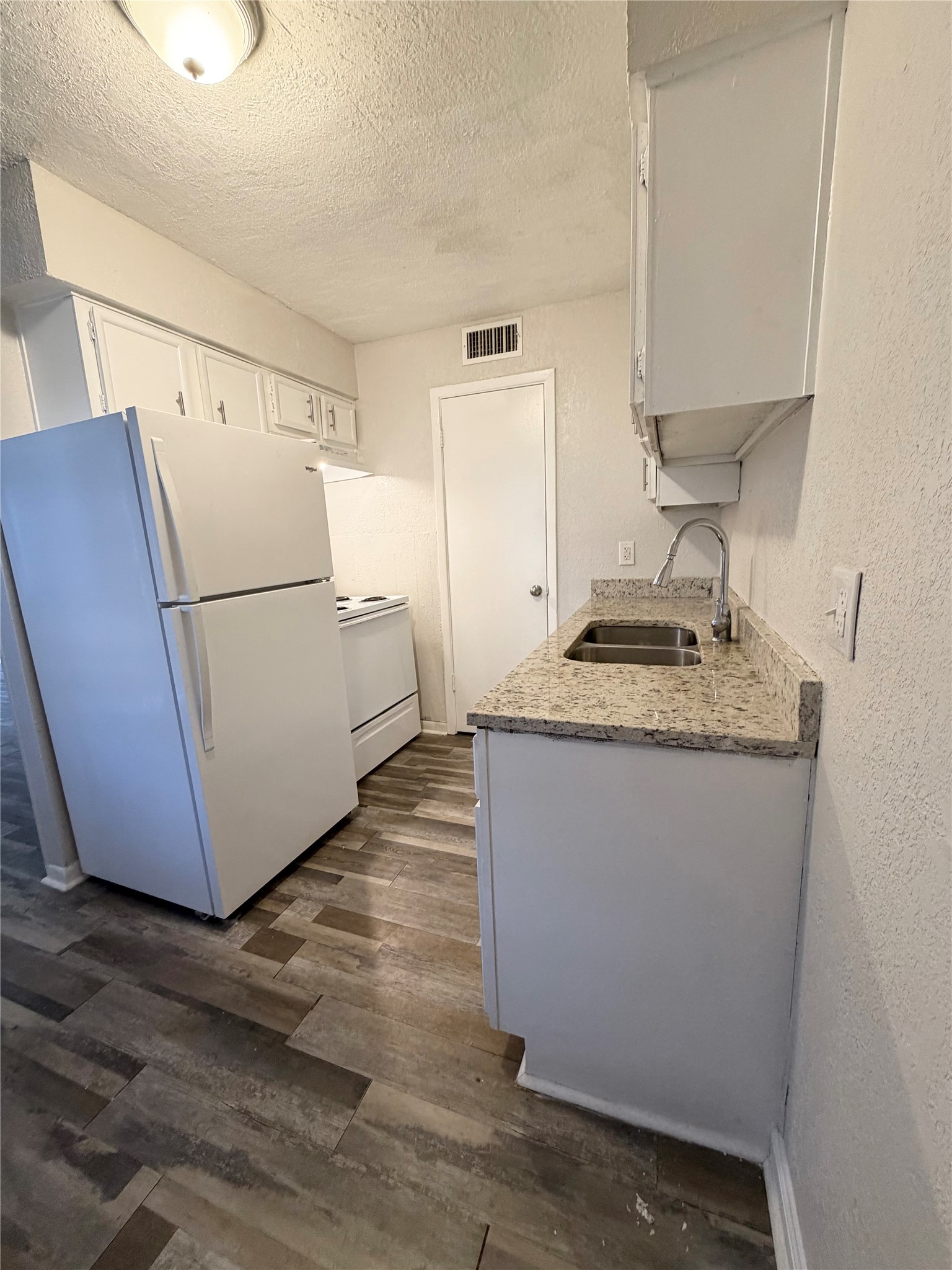 1614 Vauthier Street, Unit 11 La Marque, TX 77568 - Photo 7 of 16 a white refrigerator freezer sitting inside of a kitchen