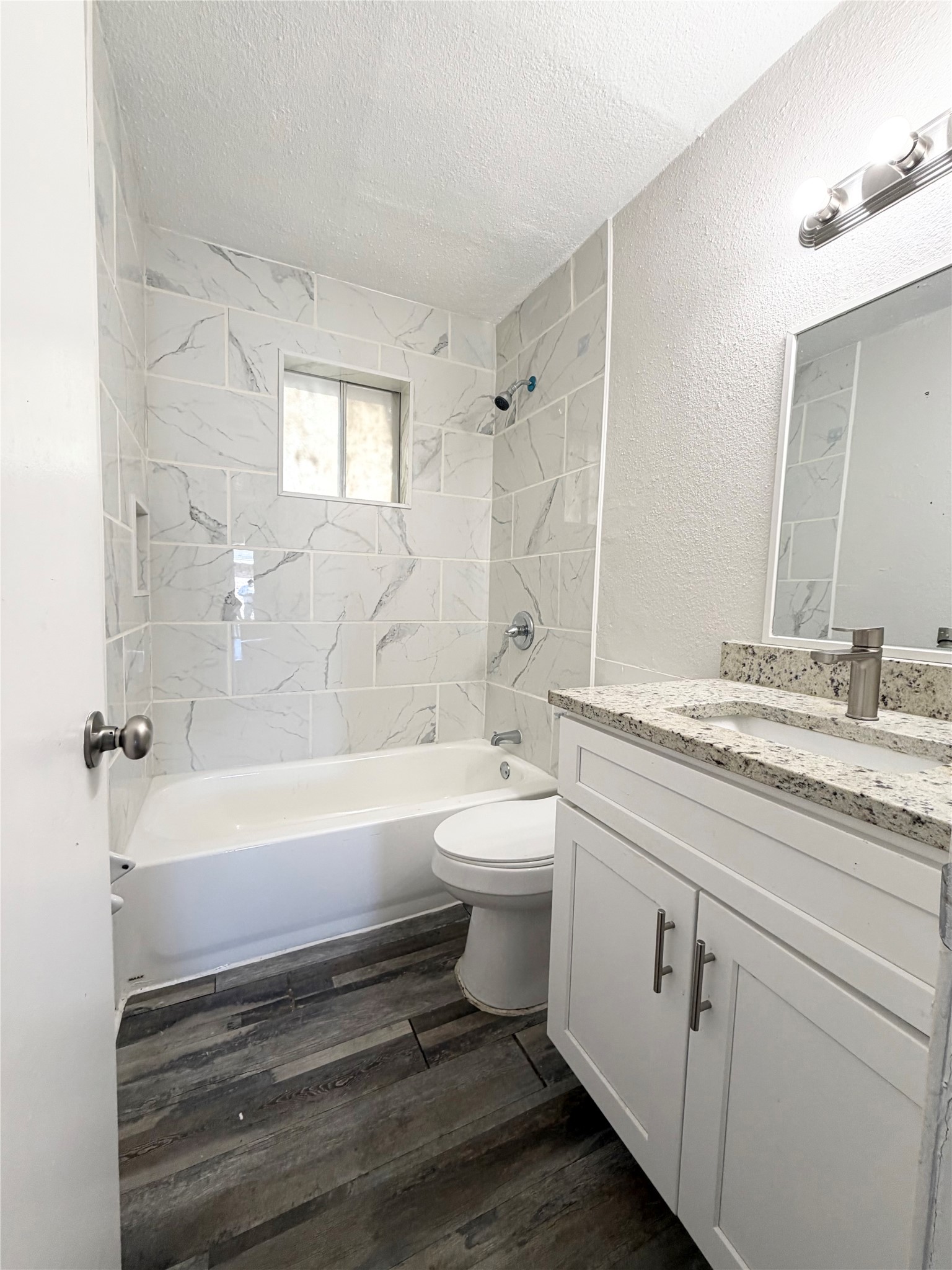 1614 Vauthier Street, Unit 11 La Marque, TX 77568 - Photo 10 of 16 a bathroom with a granite countertop toilet a sink and bathtub