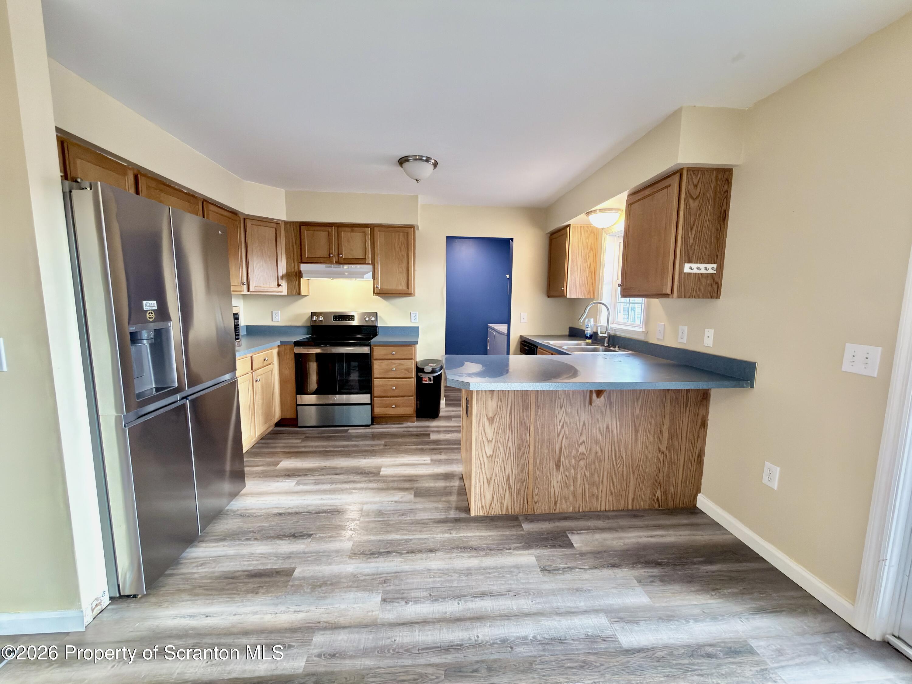 41 South Waterford Road Dalton, PA 18414 - Photo 7 of 22 a kitchen with stainless steel appliances a refrigerator and a stove