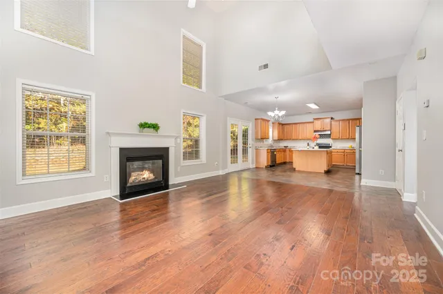 a view of empty room with wooden floor and fireplace