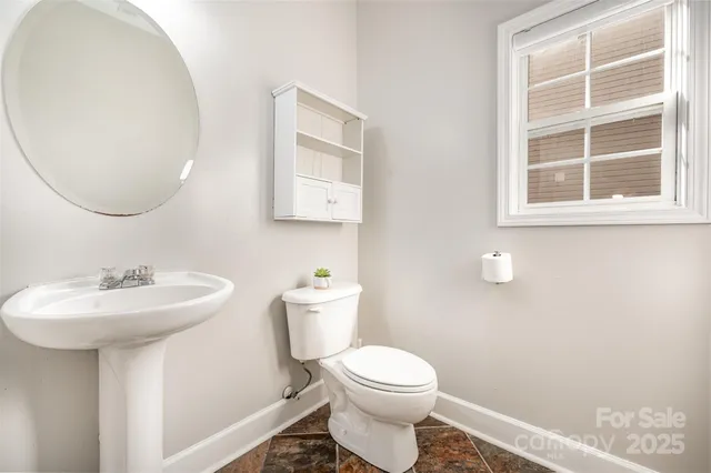 a bathroom with a sink toilet and a mirror