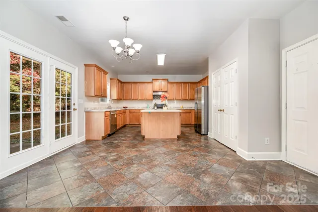 a view of a kitchen with a sink dishwasher stove and refrigerator