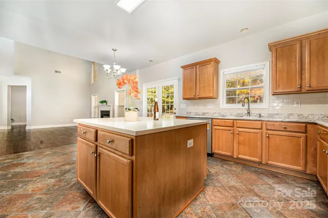 a spacious bathroom with a sink double vanity granite and a mirror