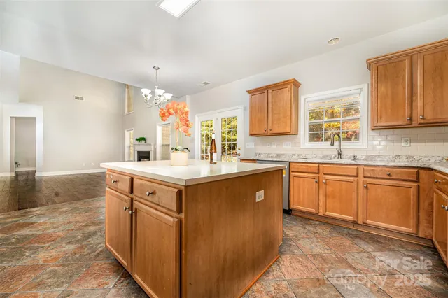 a spacious bathroom with a sink double vanity granite and a mirror