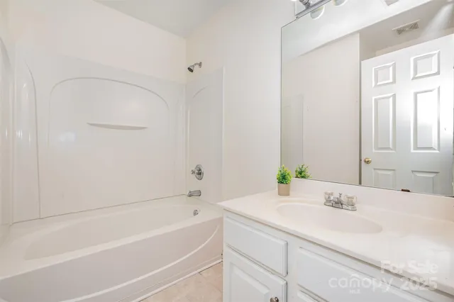 a bathroom with a bathtub and a sink