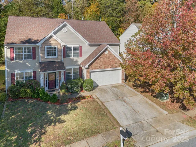a aerial view of a house next to a yard