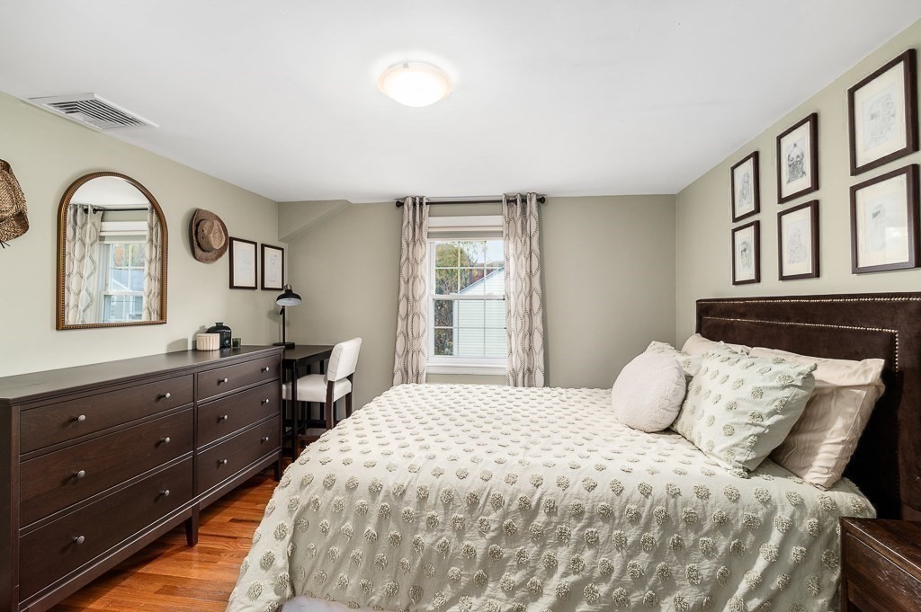 37 Tufts Road Winchester, MA 01890 - Photo 23 of 39 a bedroom with a bed and a dresser with mirror
