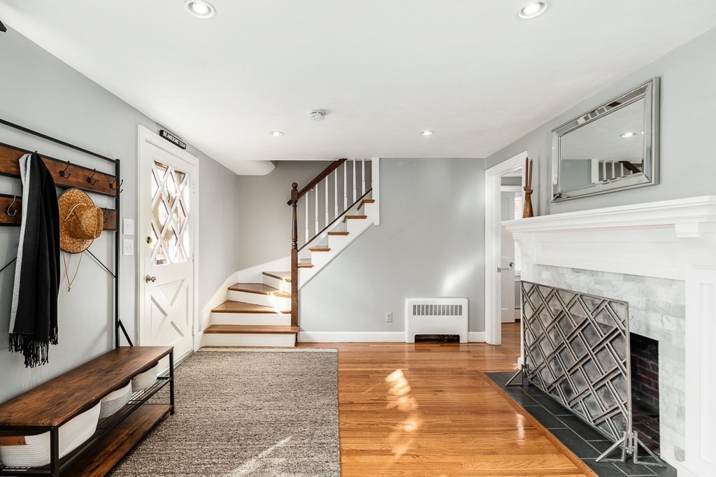 37 Tufts Road Winchester, MA 01890 - Photo 3 of 39 a living room with a fireplace and a flat screen tv