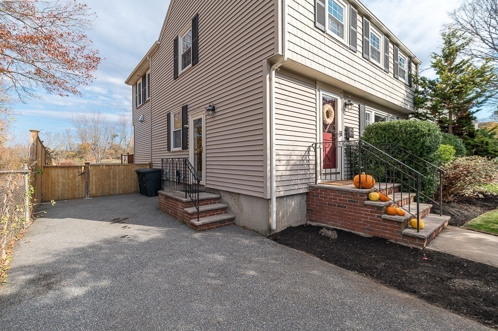37 Tufts Road Winchester, MA 01890 - Photo 37 of 39 a backyard of a house with barbeque oven and outdoor seating