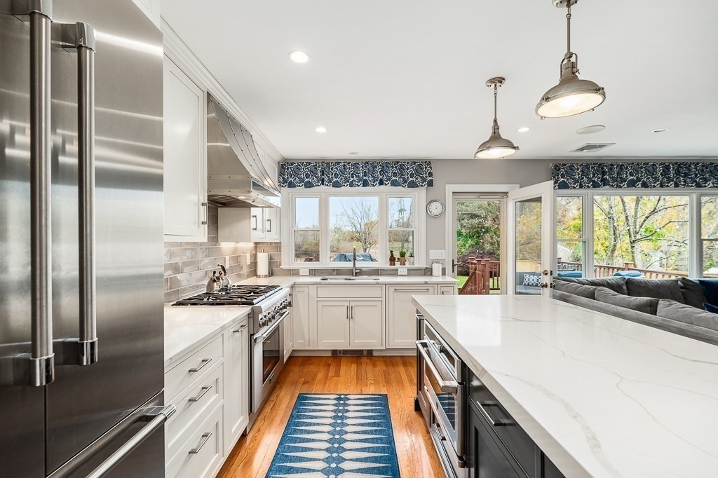 37 Tufts Road Winchester, MA 01890 - Photo 5 of 39 a kitchen with stainless steel appliances granite countertop a sink a stove and a refrigerator