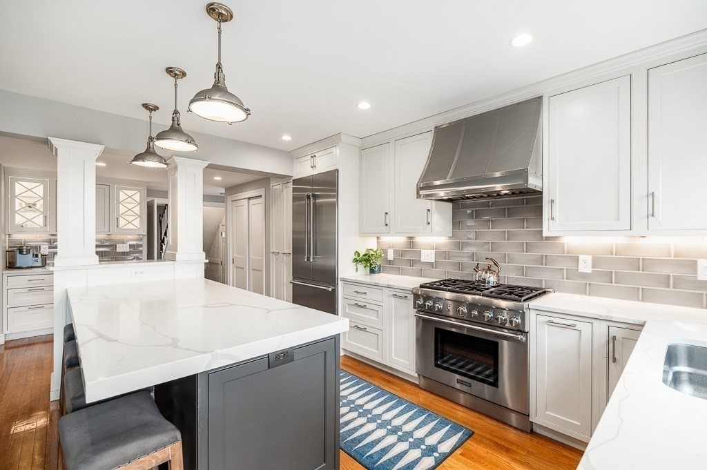 37 Tufts Road Winchester, MA 01890 - Photo 7 of 39 a kitchen with a stove a sink and a refrigerator