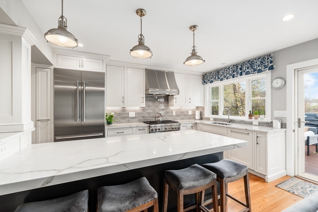 37 Tufts Road Winchester, MA 01890 - Photo 8 of 39 a kitchen with stainless steel appliances a dining table chairs and wooden floor