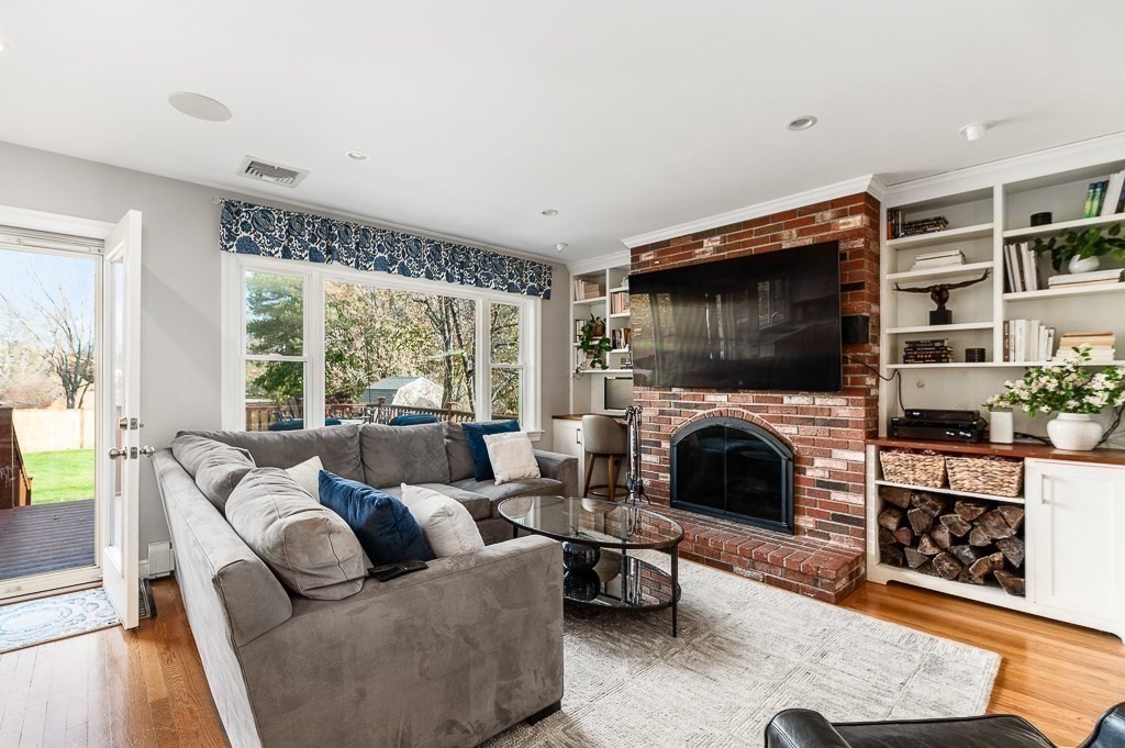 37 Tufts Road Winchester, MA 01890 - Photo 10 of 39 a living room with furniture a flat screen tv and a fireplace