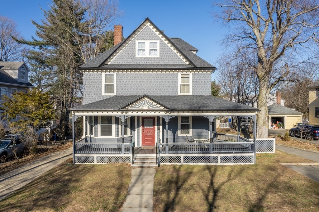 11 Jenison Street Newton, MA 02460 - Photo 1 of 42 a view of a white house with large windows and a small yard and large trees