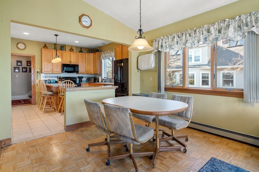 11 Jenison Street Newton, MA 02460 - Photo 11 of 42 a dining room with wooden floor a chandelier a wooden table and chairs
