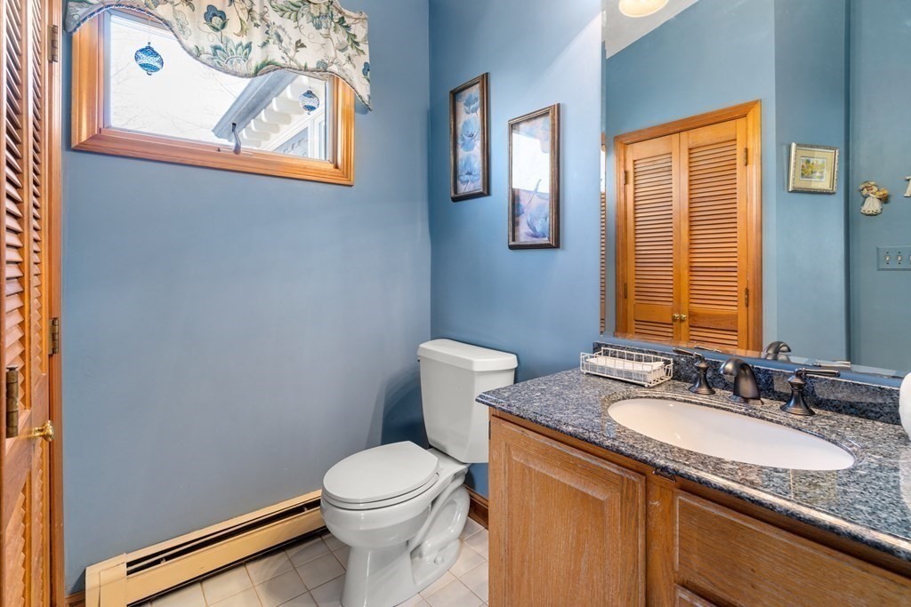 11 Jenison Street Newton, MA 02460 - Photo 18 of 42 a bathroom with a granite countertop sink and a mirror
