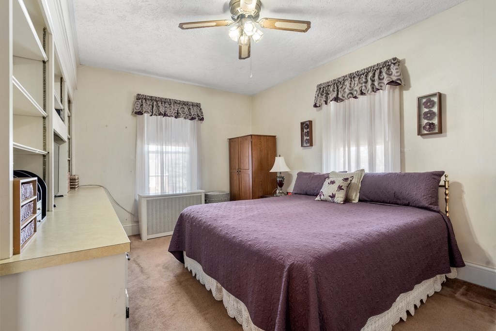 11 Jenison Street Newton, MA 02460 - Photo 20 of 42 a bedroom with a bed and a chandelier