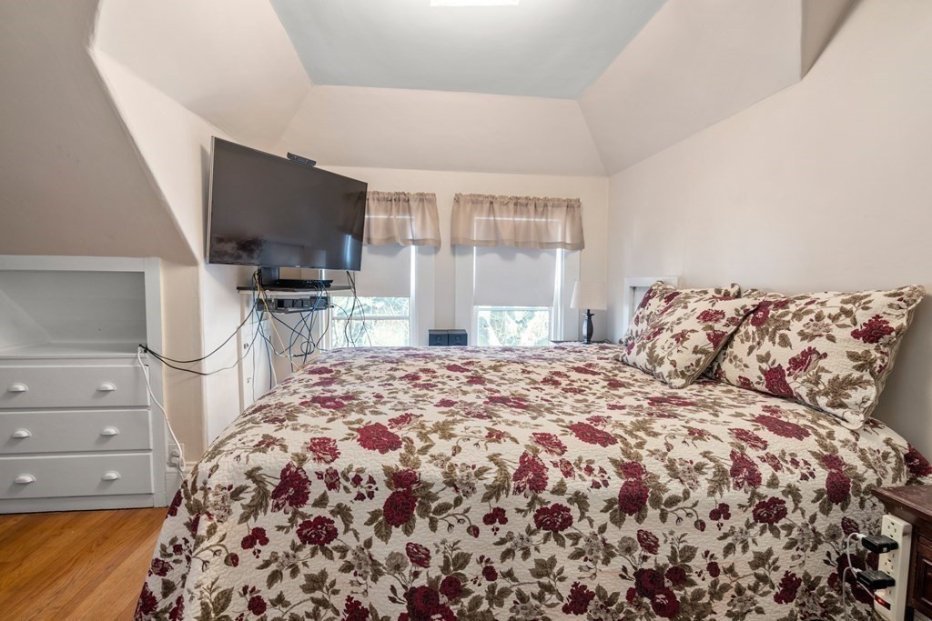 11 Jenison Street Newton, MA 02460 - Photo 25 of 42 a bedroom with a bed and flat screen tv