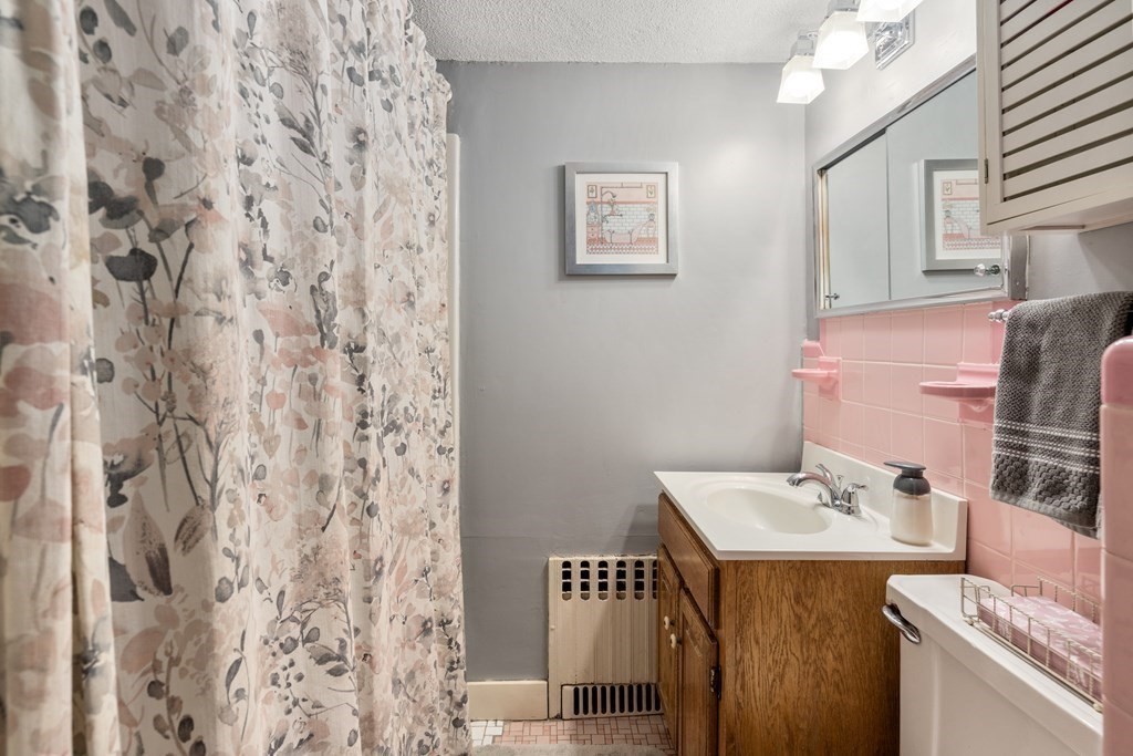 11 Jenison Street Newton, MA 02460 - Photo 26 of 42 a bathroom with a sink and a mirror