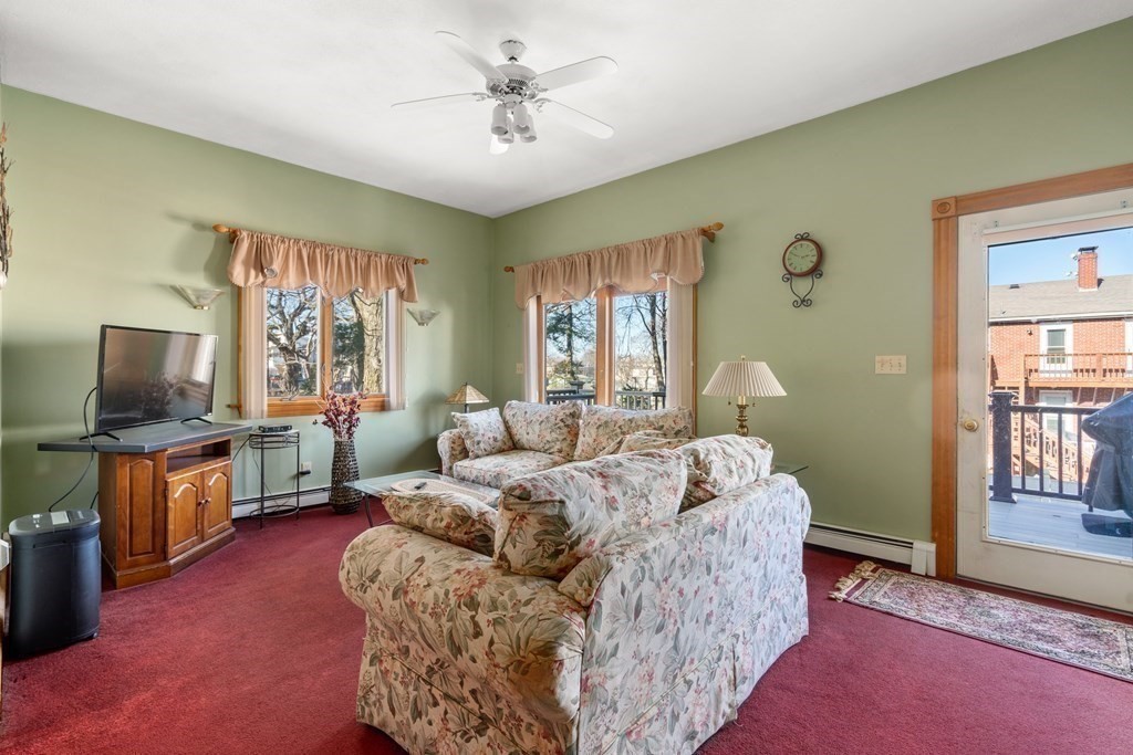 11 Jenison Street Newton, MA 02460 - Photo 28 of 42 a living room with furniture a flat screen tv and a fireplace
