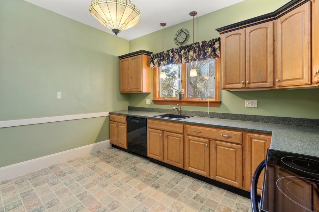 11 Jenison Street Newton, MA 02460 - Photo 29 of 42 a kitchen with granite countertop a sink stainless steel appliances and cabinets