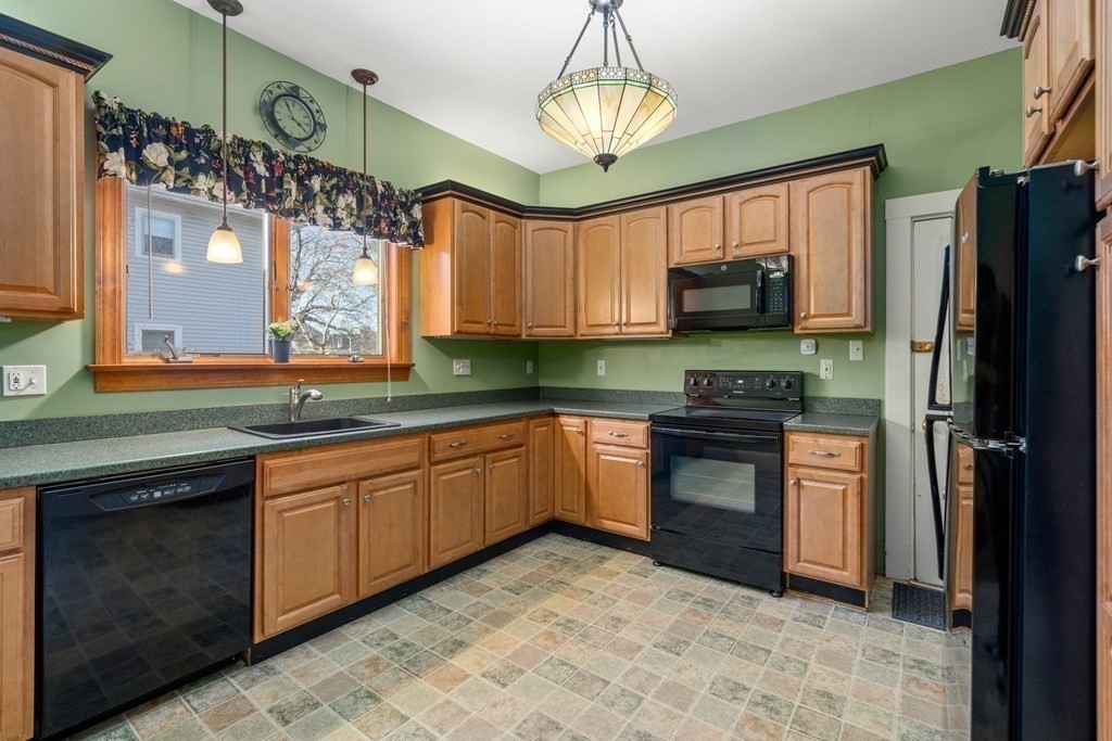 11 Jenison Street Newton, MA 02460 - Photo 30 of 42 a kitchen with stainless steel appliances granite countertop a stove refrigerator and microwave