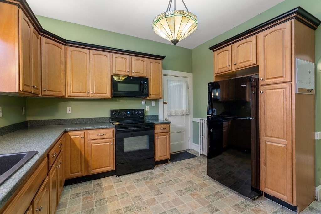 11 Jenison Street Newton, MA 02460 - Photo 31 of 42 a kitchen with stainless steel appliances granite countertop a refrigerator and a sink