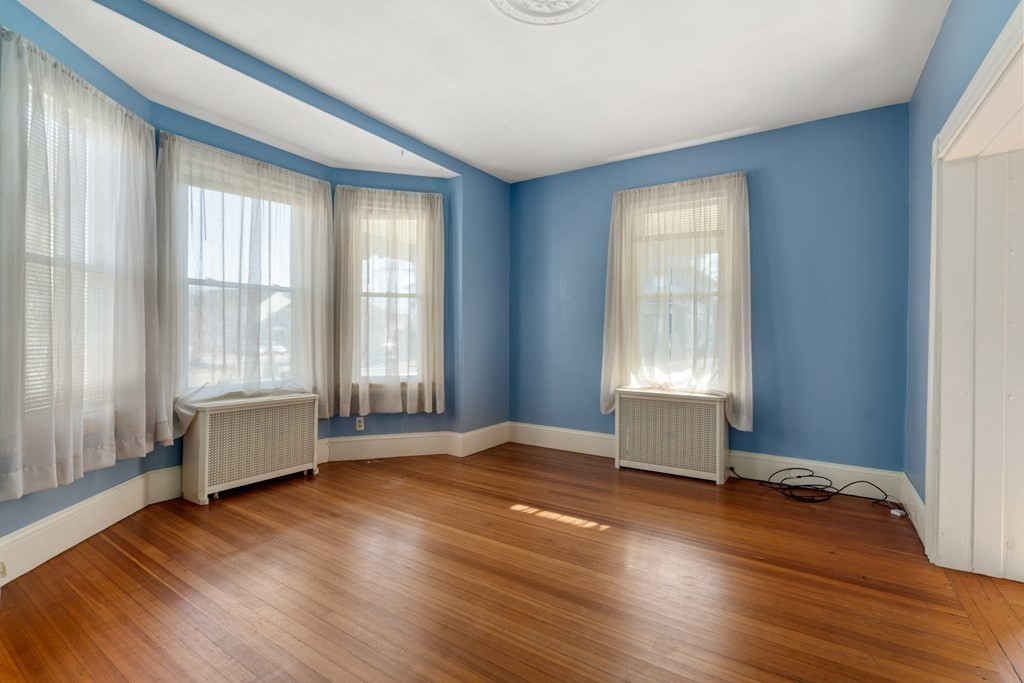 11 Jenison Street Newton, MA 02460 - Photo 33 of 42 an empty room with wooden floor and windows