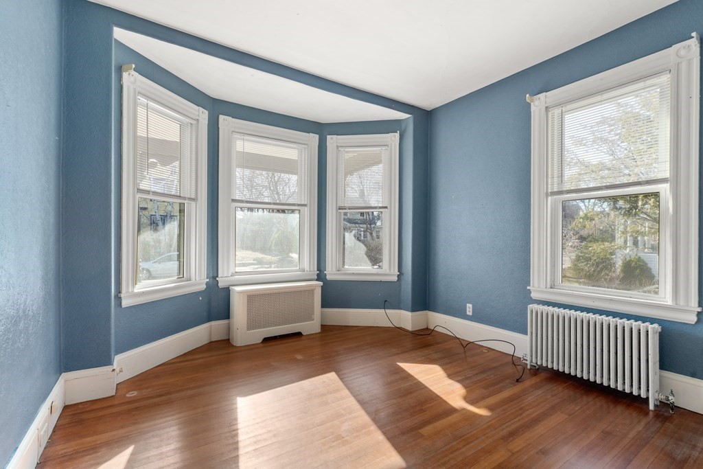 11 Jenison Street Newton, MA 02460 - Photo 34 of 42 a bedroom with a bed and wooden floor