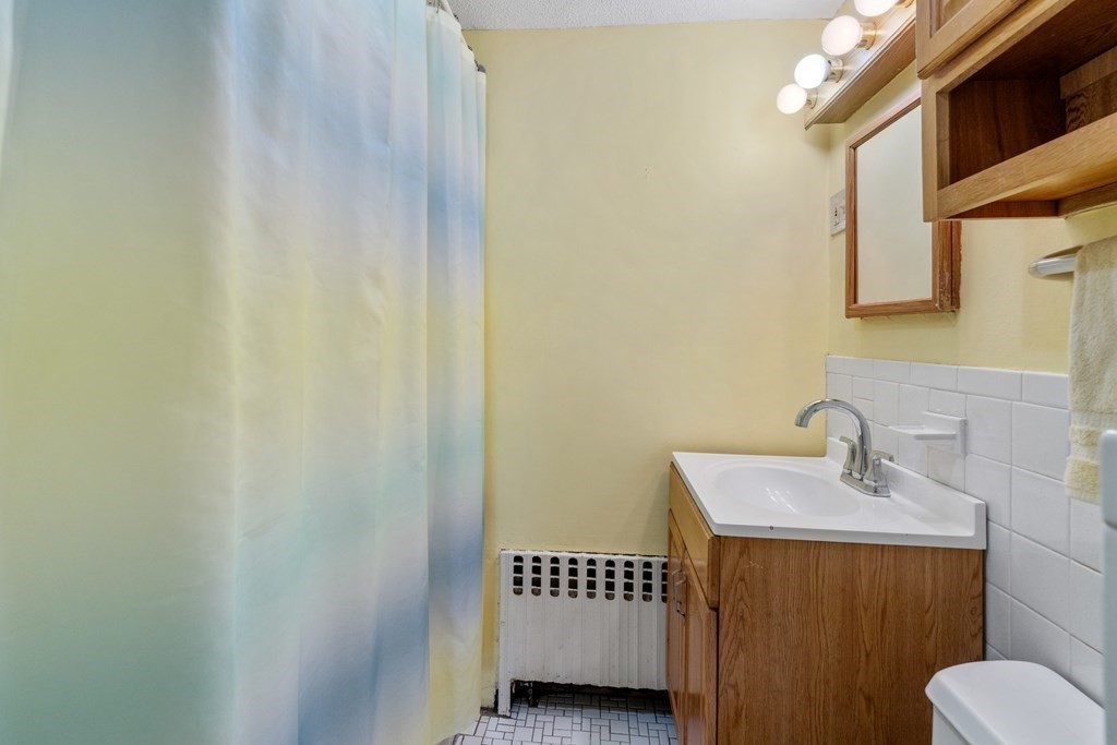 11 Jenison Street Newton, MA 02460 - Photo 36 of 42 a bathroom with a sink and a mirror