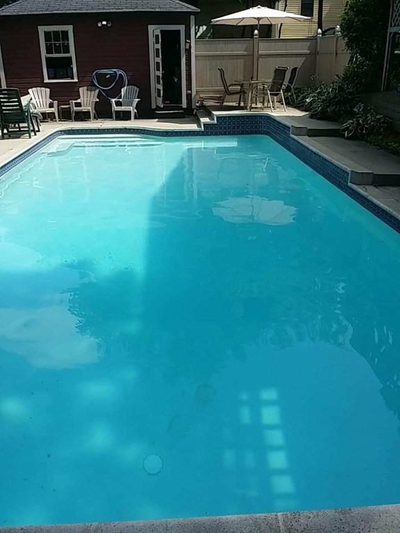 11 Jenison Street Newton, MA 02460 - Photo 42 of 42 a view of a swimming pool with lawn chairs and a yard
