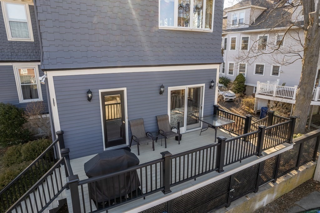 11 Jenison Street Newton, MA 02460 - Photo 5 of 42 a view of a brick house with large windows and wooden floor
