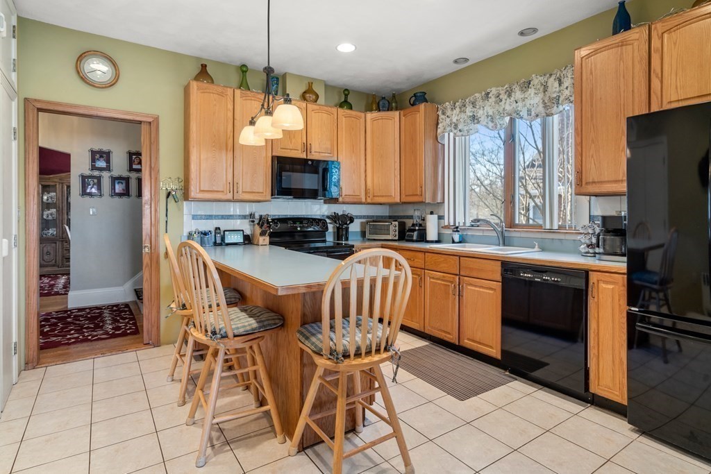 11 Jenison Street Newton, MA 02460 - Photo 9 of 42 a kitchen with stainless steel appliances a stove a sink a microwave a refrigerator and cabinets