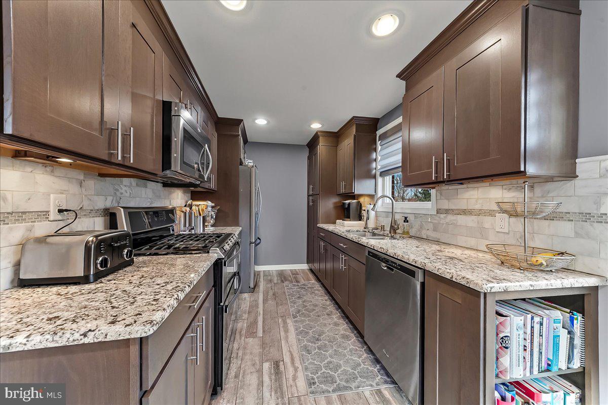 311 Laurel Road Sharon Hill, PA 19079 - Photo 13 of 28 a kitchen with stainless steel appliances granite countertop a sink stove and refrigerator