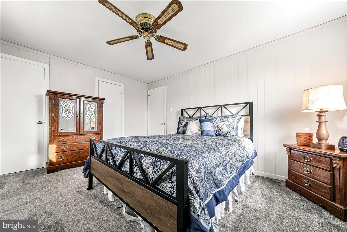 311 Laurel Road Sharon Hill, PA 19079 - Photo 17 of 28 a bedroom with a bed and a chandelier