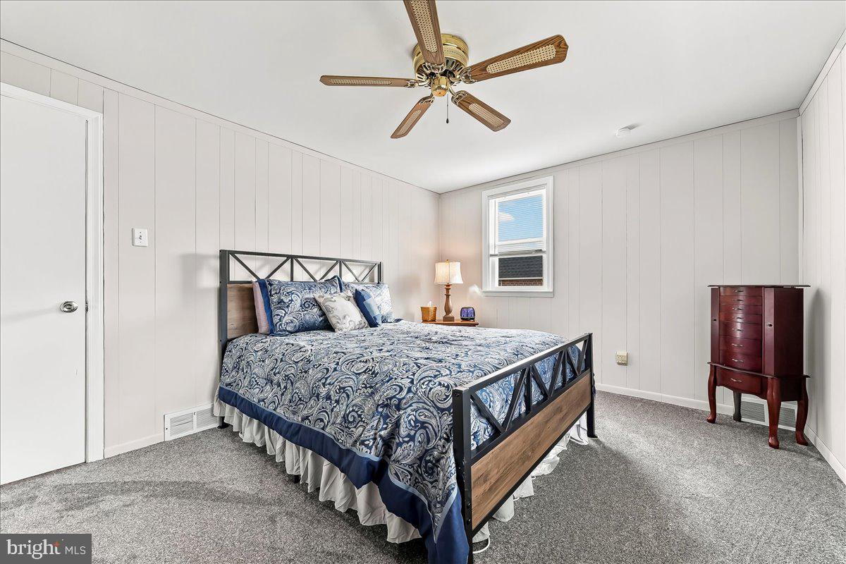 311 Laurel Road Sharon Hill, PA 19079 - Photo 19 of 28 a bedroom with a bed and a chandelier