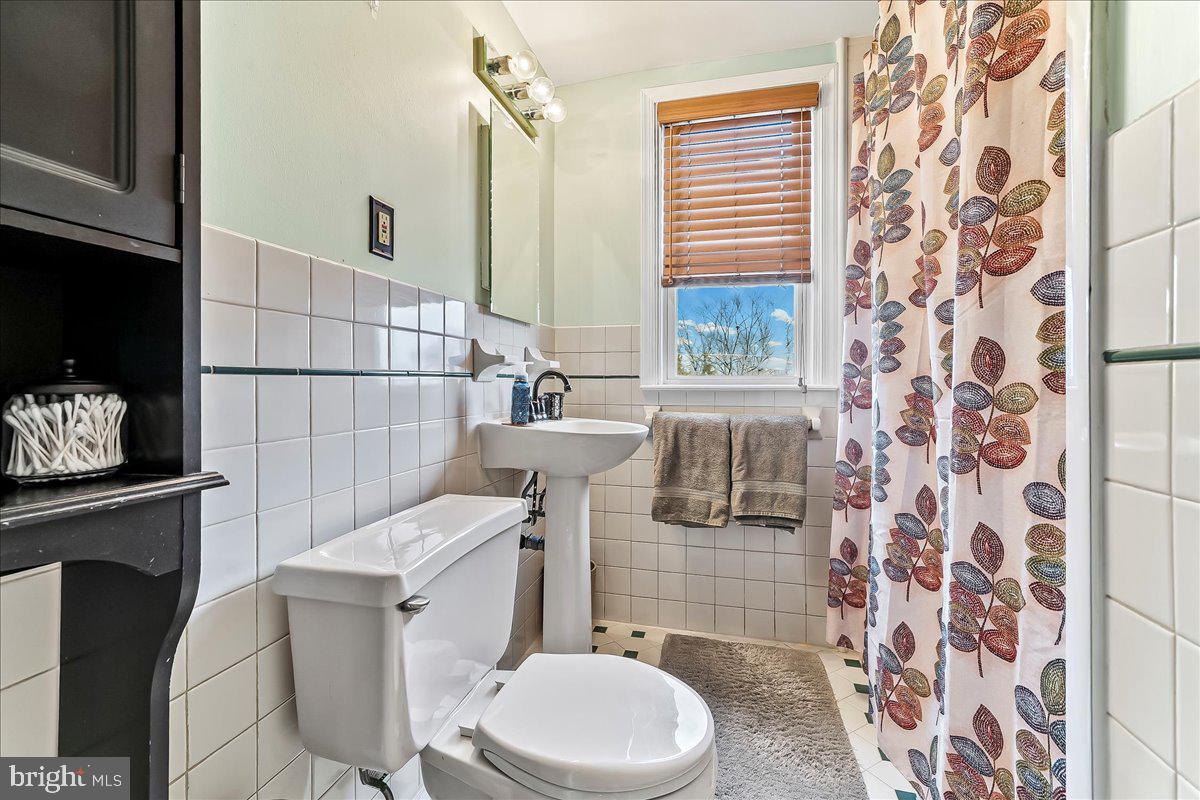 311 Laurel Road Sharon Hill, PA 19079 - Photo 20 of 28 a white toilet sitting next to a bathroom sink