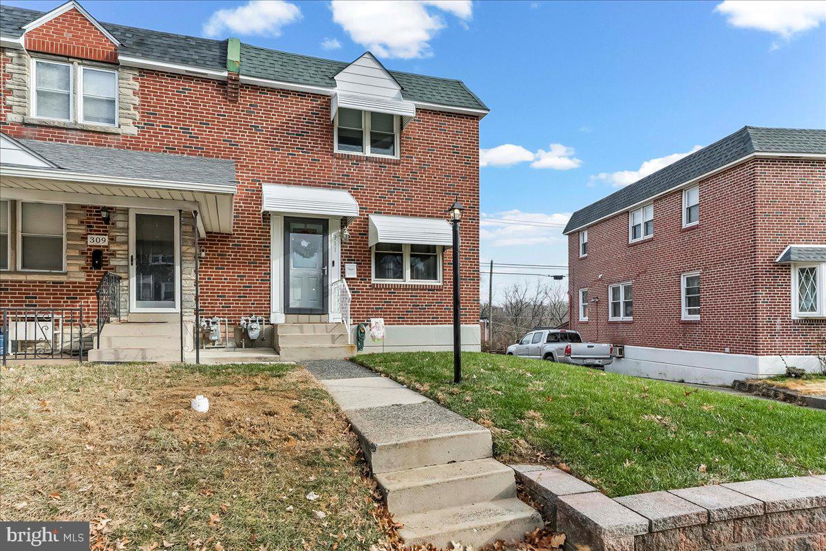 311 Laurel Road Sharon Hill, PA 19079 - Photo 2 of 28 a front view of a house with a yard