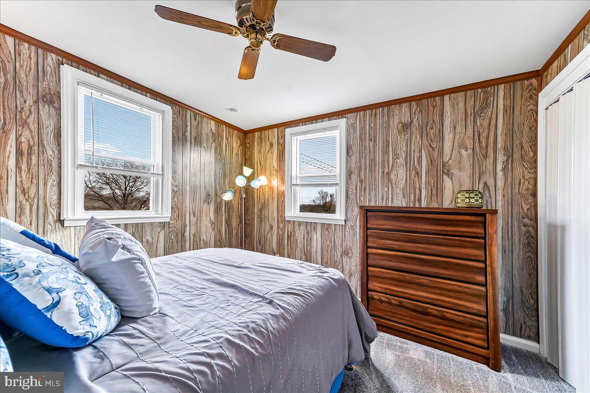 311 Laurel Road Sharon Hill, PA 19079 - Photo 22 of 28 a bedroom with a bed and a chandelier