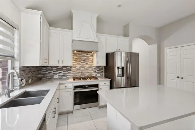 a kitchen with a stove sink and refrigerator