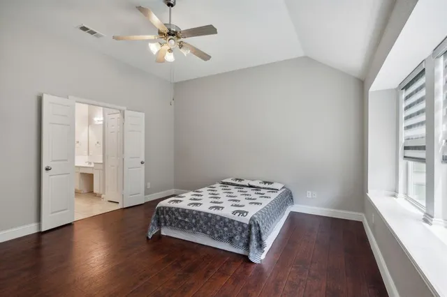 a bedroom with a bed and a window