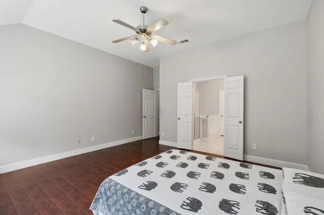a view of a bedroom with wooden floor