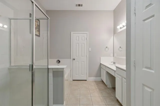 a bathroom with a tub sink and mirror