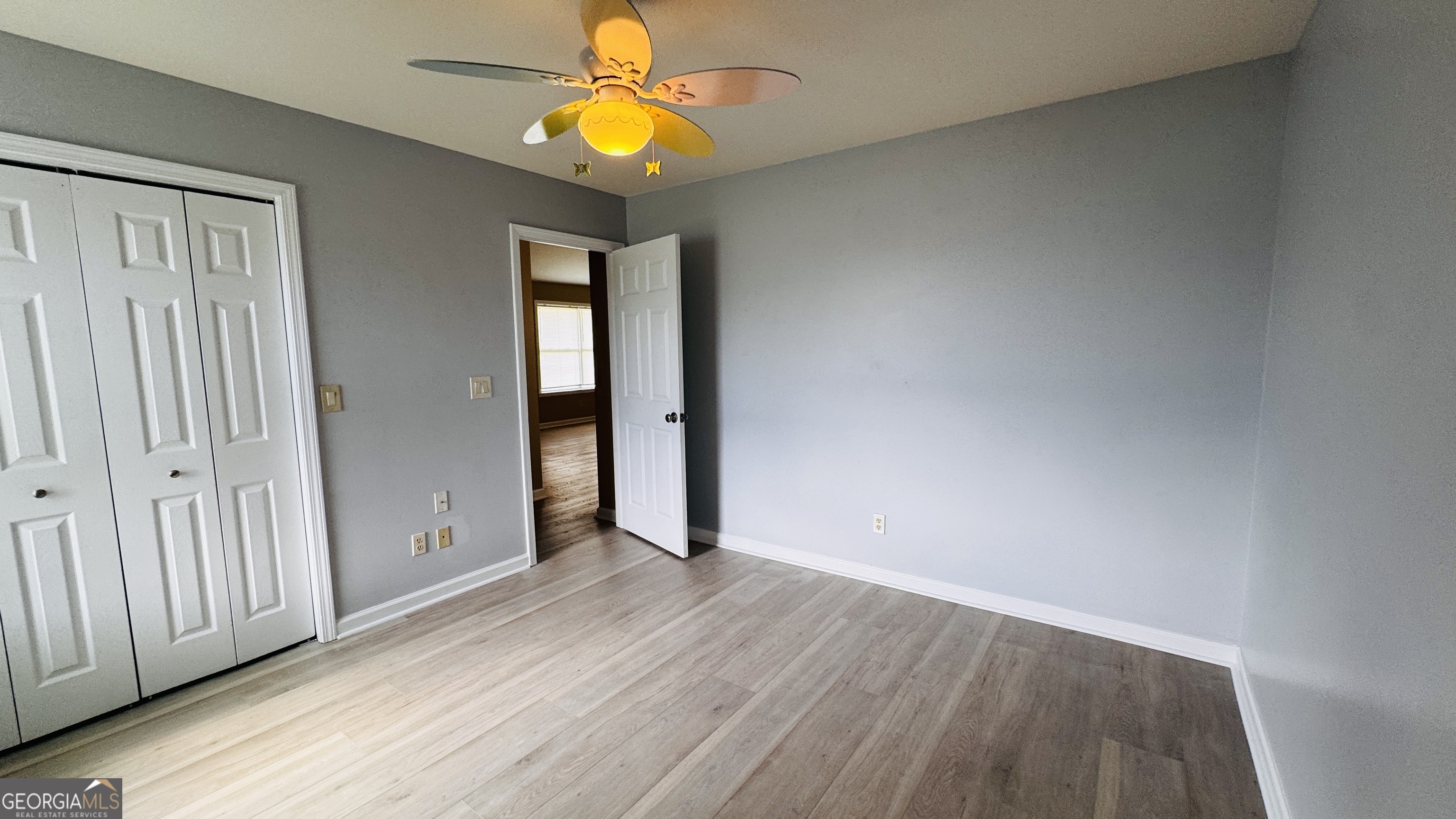 512 Antietum Road Collins, GA 30421 - Photo 11 of 16 an empty room with wooden floor and windows