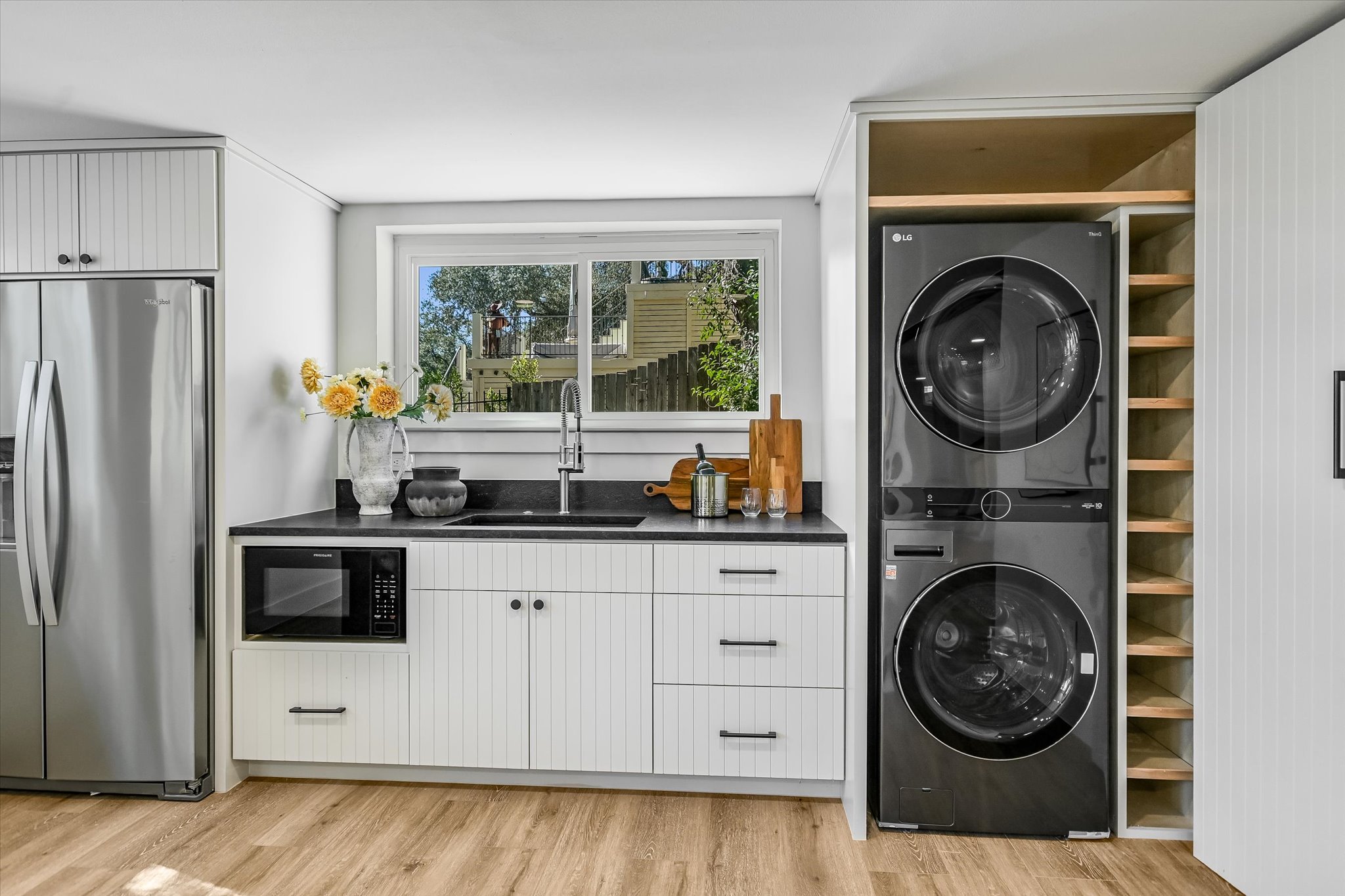 6111 Hudson Bend Road Austin, TX 78734 - Photo 14 of 40 Laundry area with light wood-style floors and stacked washer and clothes dryer