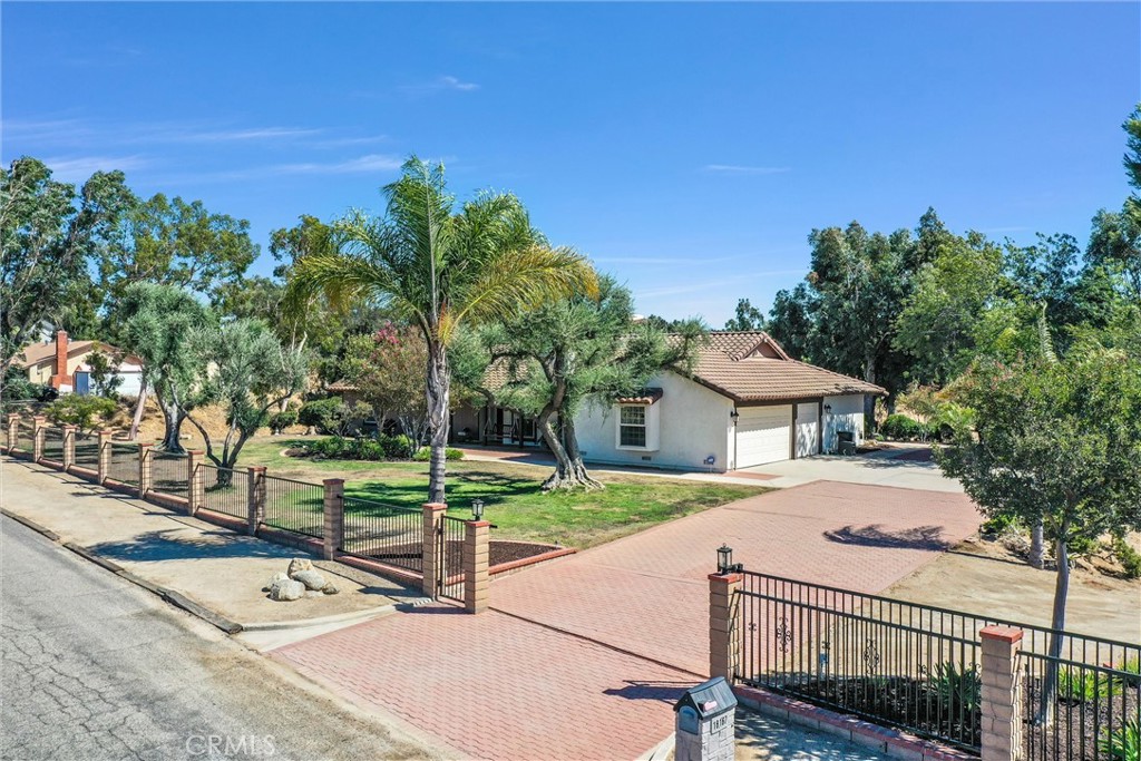 18167 Harley John Road Riverside, CA 92504 - Photo 1 of 1 a view of a house with a yard and large trees
