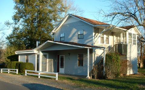 278 Riverside Drive, Unit A Hayesville, NC 28904 - Photo 1 of 5 a front view of a house with a yard