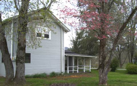 278 Riverside Drive, Unit A Hayesville, NC 28904 - Photo 3 of 5 a front view of a house with a yard