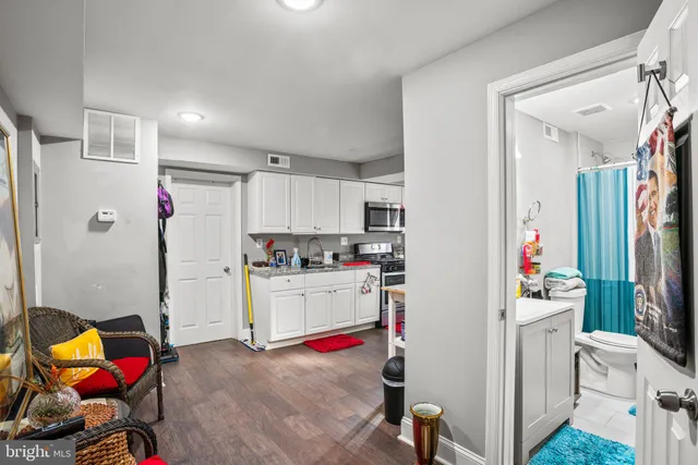 a kitchen with granite countertop a sink cabinets and appliances